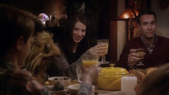 Movie still from “Turkey Hollow” (2015), directed by Kirk R. Thatcher – A group of people sitting at a table with food and drinks; Medium shot, Over the shoulder angle