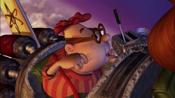Movie still from “Jimmy Neutron: Boy Genius” (2001), directed by John A. Davis – An animated character sitting on top of train tracks; Wide shot, Overhead angle