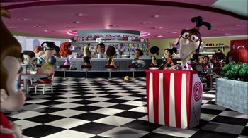 Movie still from “Jimmy Neutron: Boy Genius” (2001), directed by John A. Davis – A group of people sitting at a table in front of a checkerboard floor; Wide shot, High angle
