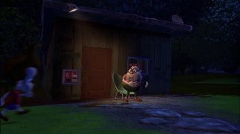 Movie still from “Jimmy Neutron: Boy Genius” (2001), directed by John A. Davis – An image of an animated character sitting in a chair in front of a building; Wide shot, High angle