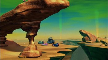 Movie still from “Jimmy Neutron: Boy Genius” (2001), directed by John A. Davis – An animated desert scene with a green sky in the background; Extreme Wide shot, High angle