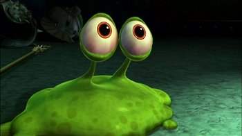 Movie still from “Jimmy Neutron: Boy Genius” (2001), directed by John A. Davis – A green creature with big eyes sitting on top of a puddle of water; Close Up shot, High angle