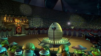 Movie still from “Jimmy Neutron: Boy Genius” (2001), directed by John A. Davis – An egg shaped fountain surrounded by a crowd of people; Extreme Wide shot, High angle
