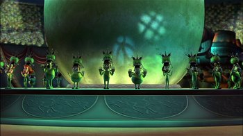 Movie still from “Jimmy Neutron: Boy Genius” (2001), directed by John A. Davis – A group of cartoon characters standing on a stage in front of an audience; Wide shot, High angle