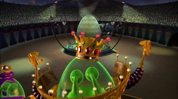 Movie still from “Jimmy Neutron: Boy Genius” (2001), directed by John A. Davis – A green statue wearing a crown in the middle of a room; Wide shot, High angle