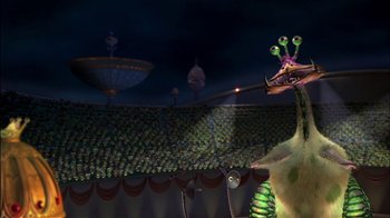 Movie still from “Jimmy Neutron: Boy Genius” (2001), directed by John A. Davis – A green and purple creature is in the middle of a stage; Medium shot, Low angle