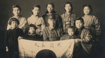 Movie still from “Jiro Dreams of Sushi” (2011), directed by David Gelb – An old photo of a group of asian people; Extreme Close Up shot, Overhead angle