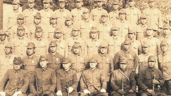 Movie still from “Jiro Dreams of Sushi” (2011), directed by David Gelb – A group of men in military uniforms posing for a picture; Extreme Close Up shot, High angle