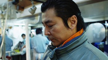 Movie still from “Jiro Dreams of Sushi” (2011), directed by David Gelb – A person on a train; Close Up shot, Low angle