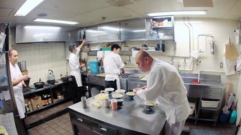 Movie still from “Jiro Dreams of Sushi” (2011), directed by David Gelb – A group of chefs preparing food inside of a kitchen; Wide shot, High angle