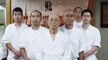 Movie still from “Jiro Dreams of Sushi” (2011), directed by David Gelb – A group of asian men in white shirts and ties; Medium shot, Low angle