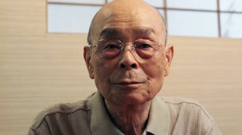 Movie still from “Jiro Dreams of Sushi” (2011), directed by David Gelb – An older man wearing glasses and a tan shirt; Close Up shot, Low angle