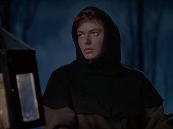 Movie still from “Joan of Arc” (1948), directed by Victor Fleming – A man wearing a black robe and a black hood; Close Up shot, Low angle
