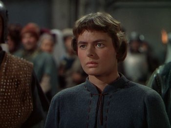 Movie still from “Joan of Arc” (1948), directed by Victor Fleming – A woman in a gray dress looking to her left; Close Up shot, Over the shoulder angle