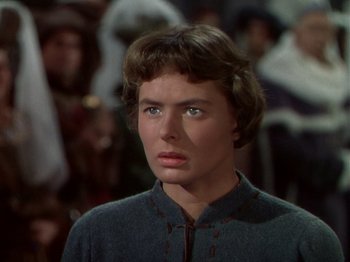 Movie still from “Joan of Arc” (1948), directed by Victor Fleming – A young woman with blue eyes stares into the distance; Close Up shot, Over the shoulder angle