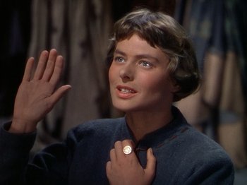 Movie still from “Joan of Arc” (1948), directed by Victor Fleming – A young woman holding her hand up to her face; Close Up shot, Over the shoulder angle