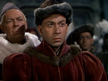 Movie still from “Joan of Arc” (1948), directed by Victor Fleming – A person wearing a fur hat; Close Up shot, Over the shoulder angle