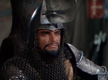 Movie still from “Joan of Arc” (1948), directed by Victor Fleming – A person wearing a helmet and chain mail armor; Close Up shot, High angle