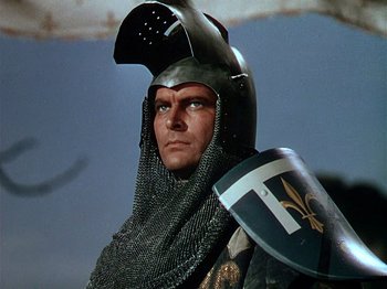 Movie still from “Joan of Arc” (1948), directed by Victor Fleming – A man wearing a knight's helmet and holding a shield; Close Up shot, Low angle
