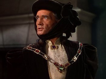 Movie still from “Joan of Arc” (1948), directed by Victor Fleming – A person wearing a hat and a necklace; Close Up shot, High angle