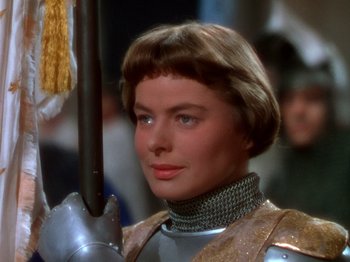 Movie still from “Joan of Arc” (1948), directed by Victor Fleming – A person wearing a suit of armor; Close Up shot, Over the shoulder angle