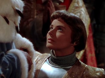 Movie still from “Joan of Arc” (1948), directed by Victor Fleming – A man in a suit of armor looking up at something; Close Up shot, Over the shoulder angle
