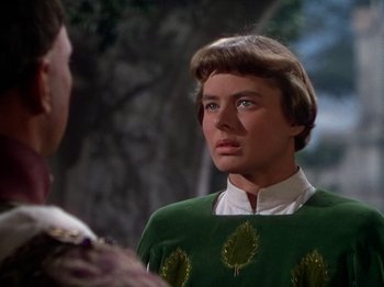 Movie still from “Joan of Arc” (1948), directed by Victor Fleming – A man wearing a green sweater with leaves on it; Close Up shot, Over the shoulder angle
