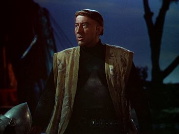 Movie still from “Joan of Arc” (1948), directed by Victor Fleming – A person wearing a suit and tie; Medium shot, Low angle