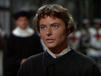 Movie still from “Joan of Arc” (1948), directed by Victor Fleming – A person wearing a suit and tie; Close Up shot, Over the shoulder angle