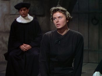 Movie still from “Joan of Arc” (1948), directed by Victor Fleming – A man and a woman standing next to each other; Medium shot, Over the shoulder angle