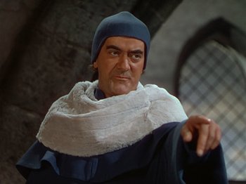 Movie still from “Joan of Arc” (1948), directed by Victor Fleming – A person wearing a hat and a scarf; Medium shot, Low angle