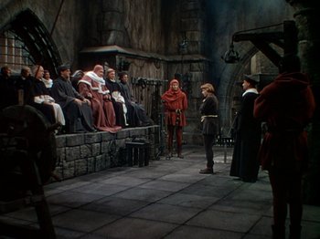 Movie still from “Joan of Arc” (1948), directed by Victor Fleming – A group of people standing in a room; Wide shot, High angle