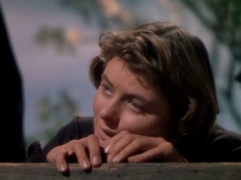Movie still from “Joan of Arc” (1948), directed by Victor Fleming – A person leaning on a fence; Close Up shot, Low angle