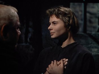 Movie still from “Joan of Arc” (1948), directed by Victor Fleming – A young man is holding his hands up to his chest; Close Up shot, Over the shoulder angle