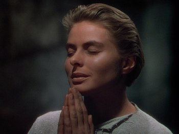 Movie still from “Joan of Arc” (1948), directed by Victor Fleming – A woman with her eyes closed is holding her hands in prayer; Close Up shot, Low angle