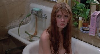 Movie still from “Joe” (1970), directed by John G. Avildsen – A woman sitting in a bathroom sink with long brown hair; Close Up shot, High angle