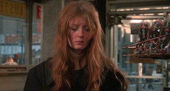 Movie still from “Joe” (1970), directed by John G. Avildsen – A woman with long red hair is looking down; Close Up shot, Low angle