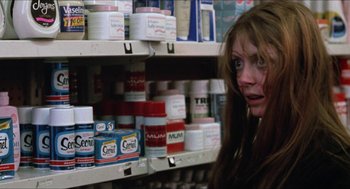 Movie still from “Joe” (1970), directed by John G. Avildsen – A woman in a grocery store looking at the camera; Close Up shot, Low angle