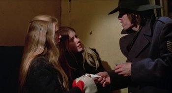 Movie still from “Joe” (1970), directed by John G. Avildsen – A group of women standing next to each other in a room; Medium shot, Over the shoulder angle