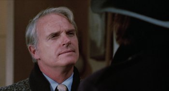 Movie still from “Joe” (1970), directed by John G. Avildsen – An older man wearing a suit and tie looking at another man; Close Up shot, Over the shoulder angle