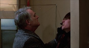 Movie still from “Joe” (1970), directed by John G. Avildsen – An older man and a younger woman laughing together; Close Up shot, Low angle