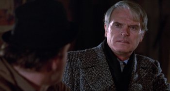 Movie still from “Joe” (1970), directed by John G. Avildsen – An older man wearing a suit and tie looking at a young man; Close Up shot, Over the shoulder angle