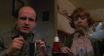 Movie still from “Joe” (1970), directed by John G. Avildsen – A man and a woman sitting at a dinner table; Close Up shot, Low angle