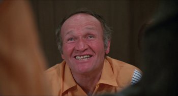 Movie still from “Joe” (1970), directed by John G. Avildsen – An older man with a big smile on his face; Close Up shot, High angle