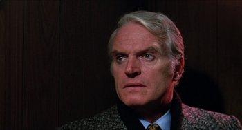 Movie still from “Joe” (1970), directed by John G. Avildsen – An older man wearing a suit and tie; Close Up shot, Low angle