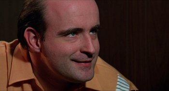 Movie still from “Joe” (1970), directed by John G. Avildsen – A person smiling for the camera; Close Up shot, Low angle