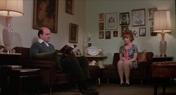 Movie still from “Joe” (1970), directed by John G. Avildsen – A man and a woman sitting in a living room; Wide shot, Over the shoulder angle