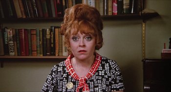 Movie still from “Joe” (1970), directed by John G. Avildsen – An older woman in a black and white polka dot dress; Close Up shot, High angle