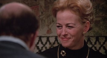 Movie still from “Joe” (1970), directed by John G. Avildsen – An older woman smiling at a younger man in a restaurant; Close Up shot, Over the shoulder angle