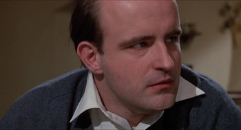 Movie still from “Joe” (1970), directed by John G. Avildsen – A person wearing a suit and tie; Close Up shot, Low angle